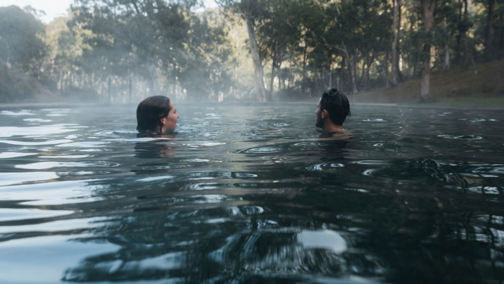 Couple enjoying a dip in the natural thermal springs in the Yarrongobilly area, Kosciuszko National Park